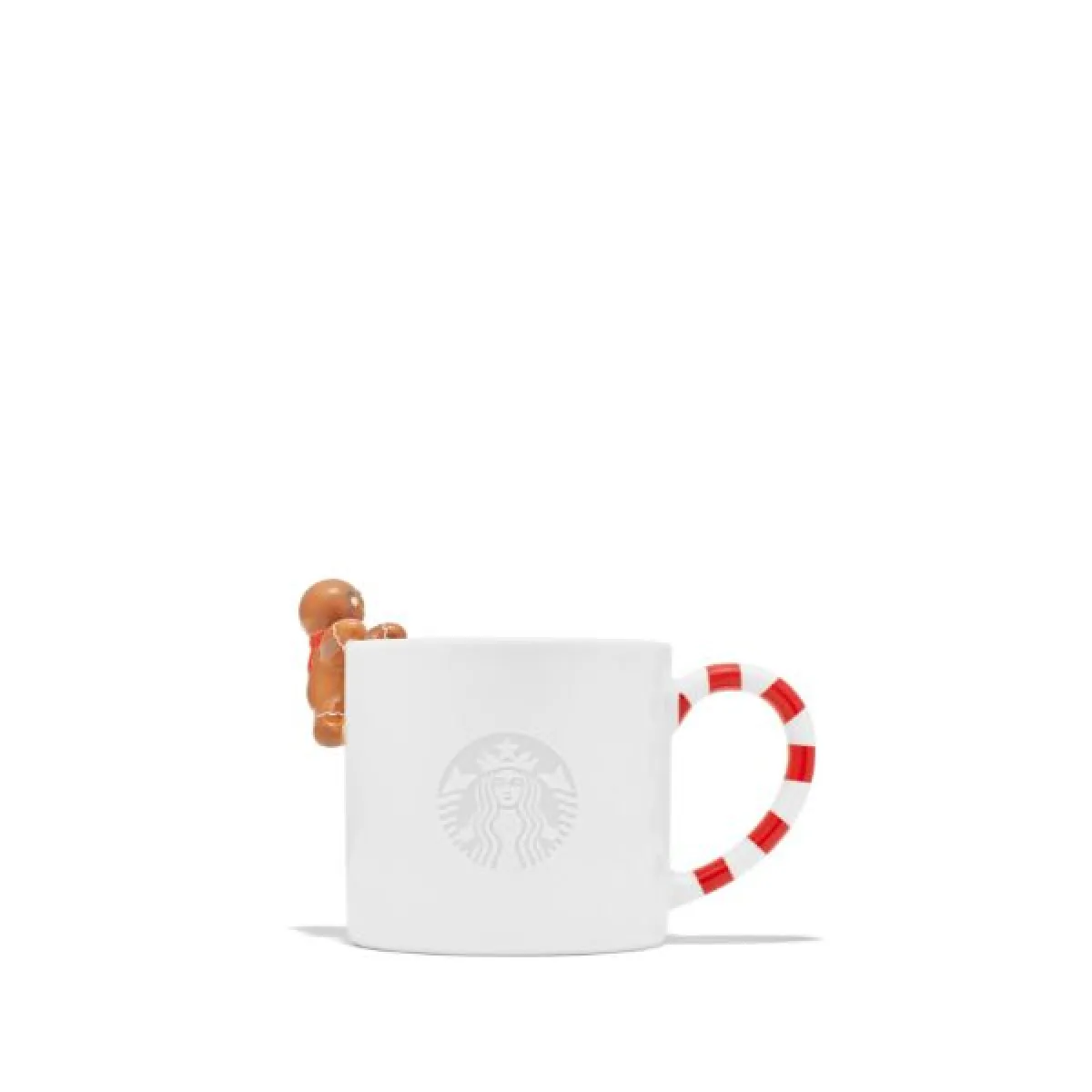 Biała porcelanowa filiżanka z logo Starbucks, z uchwytem w czerwono-białe paski przypominające laskę cukrową. Na brzegu filiżanki znajduje się figurka małego piernikowego ludzika